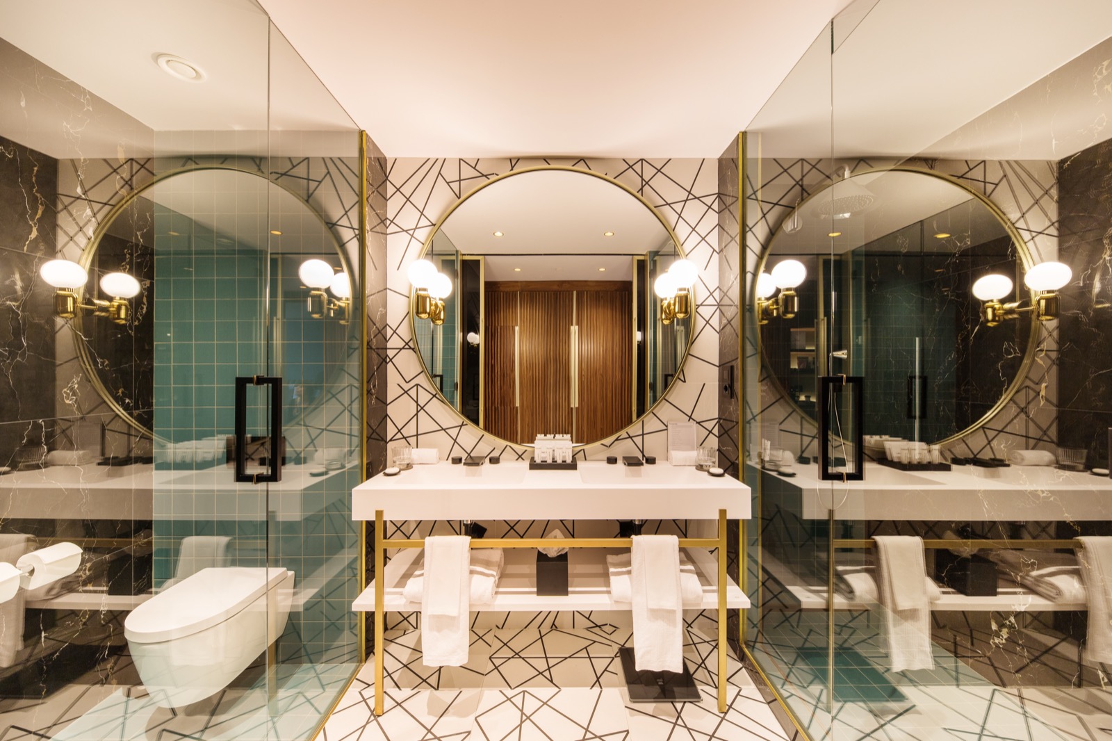 Marble bathroom with a round mirror and a double vanity