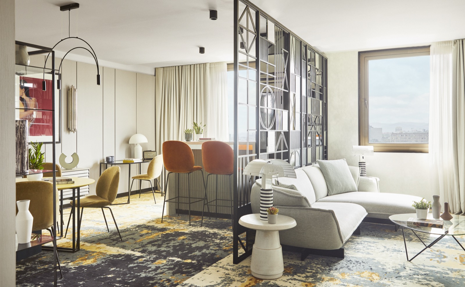 Suite living area with a mirrored partition and a city view