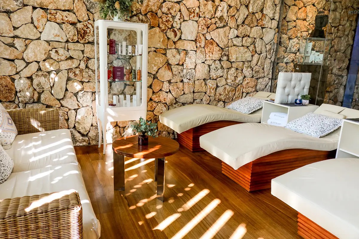 Spa relaxation loungers against a stone wall