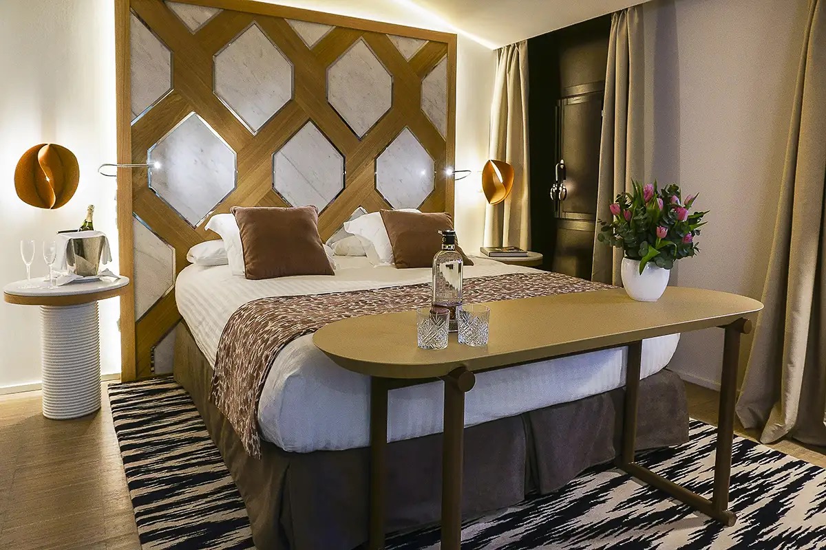Guest room bed with carved wooden and marble headboard