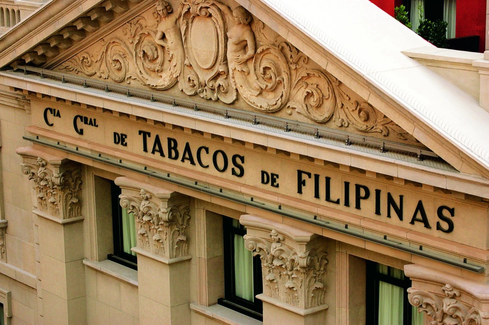 Carved stone pediment on Hotel 1898's facade on La Rambla, inscribed "Cia Gral de Tabacos de Filipinas" from the building's origin as the Philippine Tobacco Company headquarters