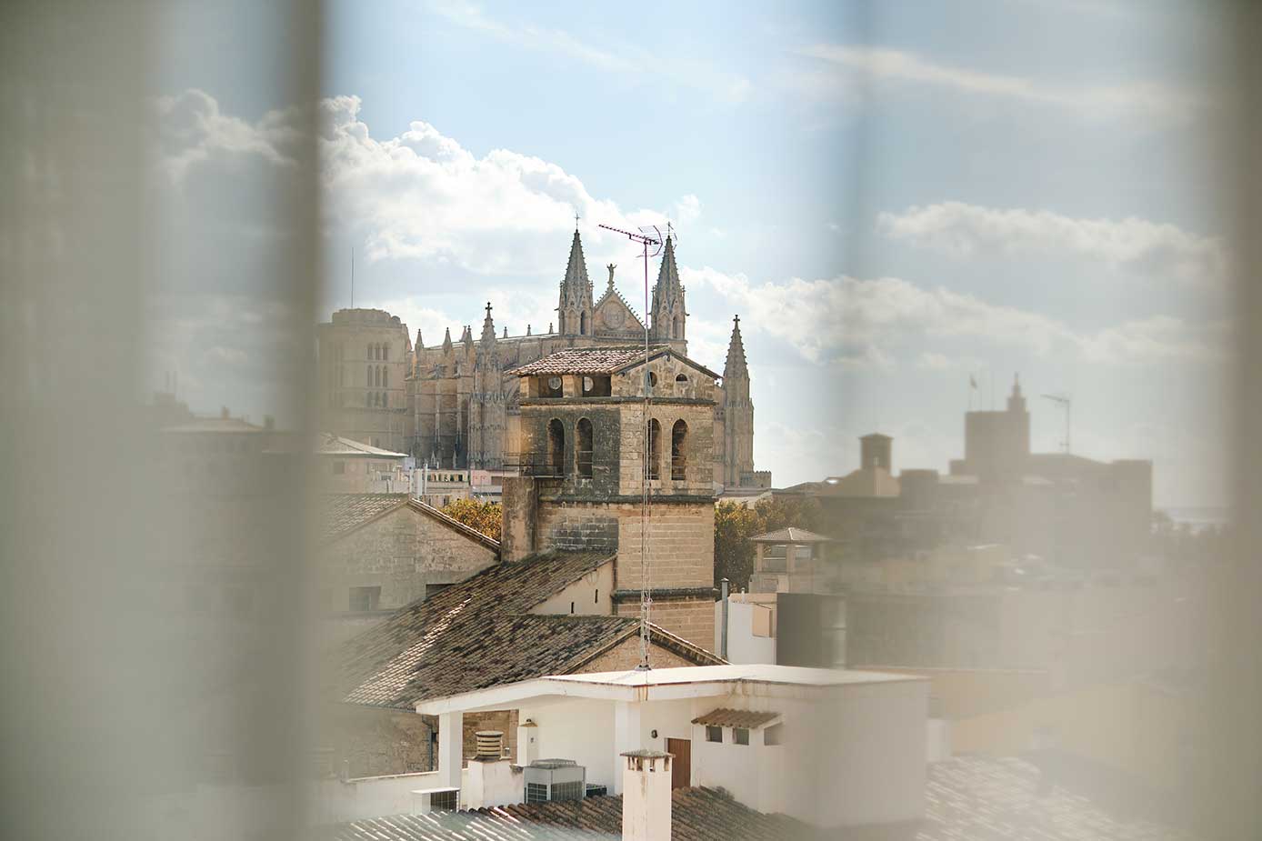 Palma Cathedral's spires seen through a guest room's sheer curtains