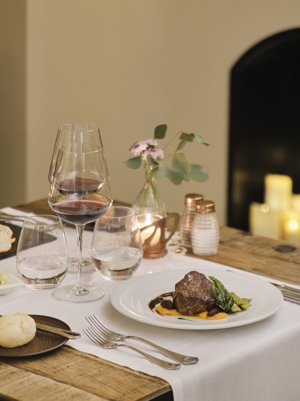 Table set with wine glasses and a plated dish at the hotel restaurant