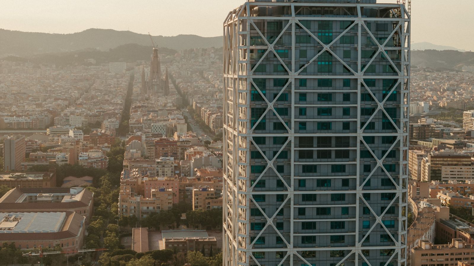 Aerial view of the Hotel Arts tower with the Barcelona skyline behind