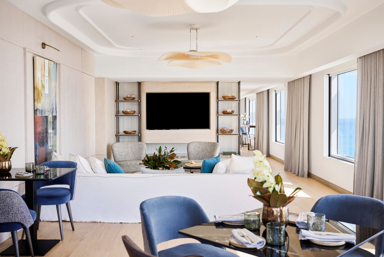 Suite living and dining room with panoramic sea-view windows