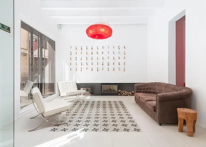 Lobby lounge with white leather chairs, a brown tufted sofa and a fireplace