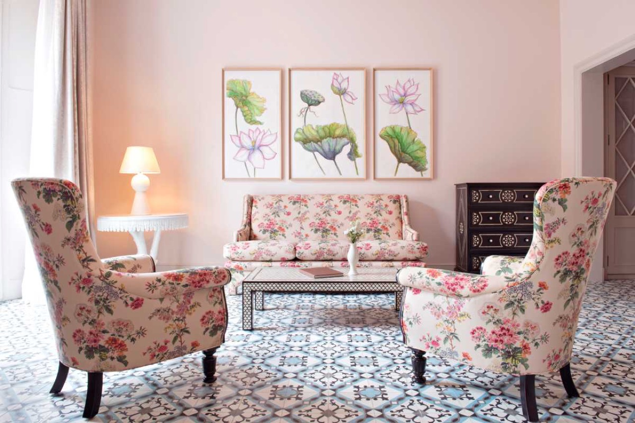 Suite living room with floral armchairs and patterned tile floor