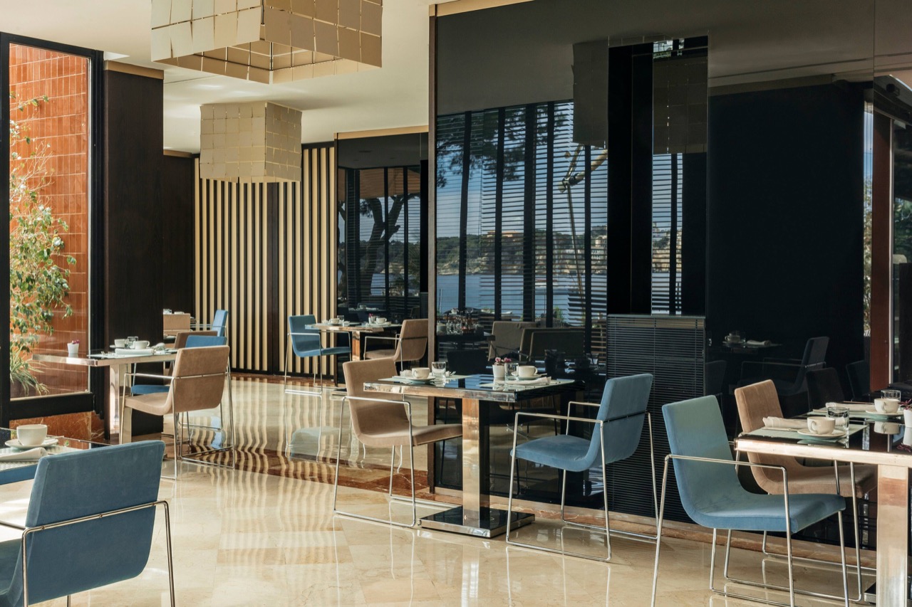Restaurant dining area with sea view through floor to ceiling windows