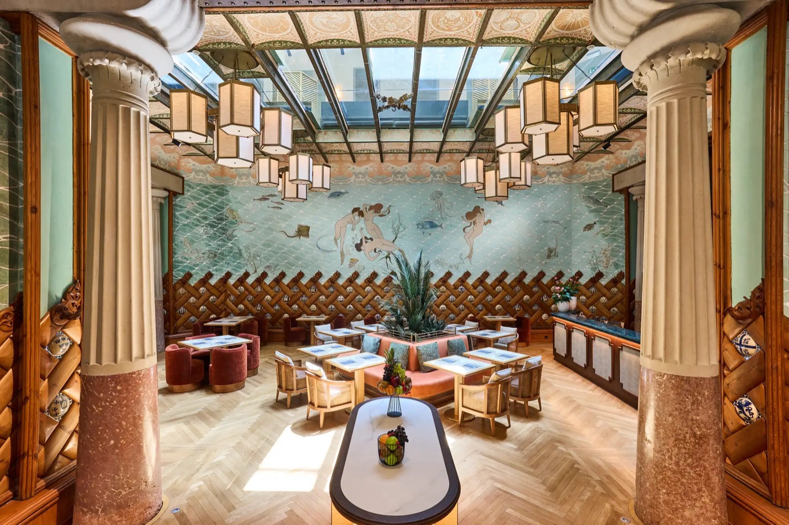 Fonda España dining room with an Art Nouveau mermaid mural and Ionic columns
