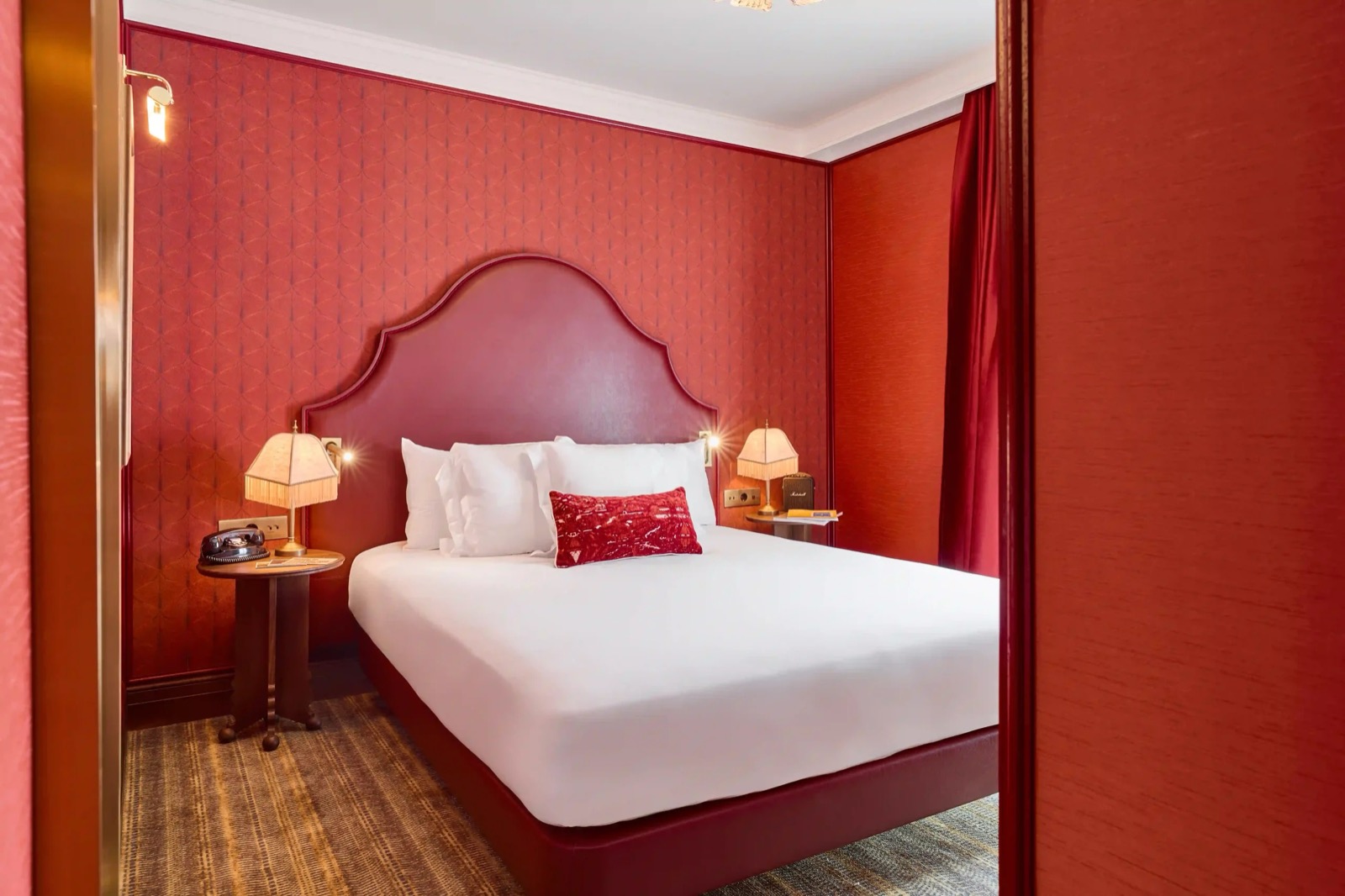 Boutique room with a red leather headboard and red walls