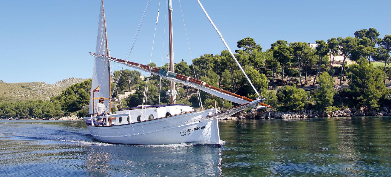 The hotel's restored sailboat Isabel Maria under sail along the Mallorcan coast