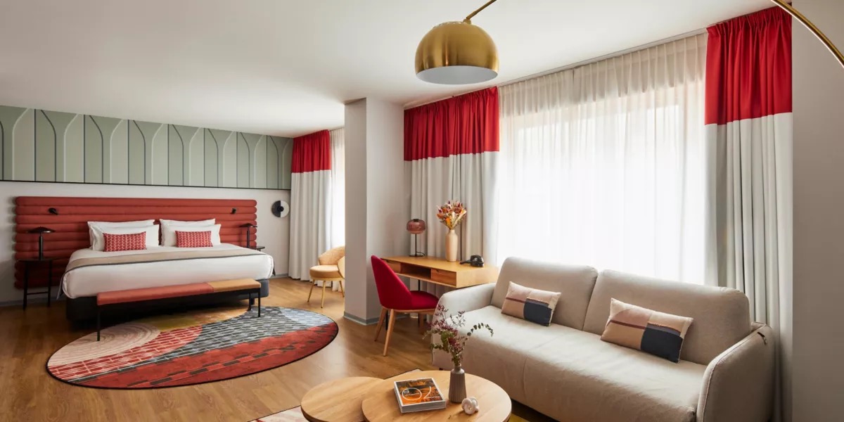 Suite with a bed, a seating area and a sofa