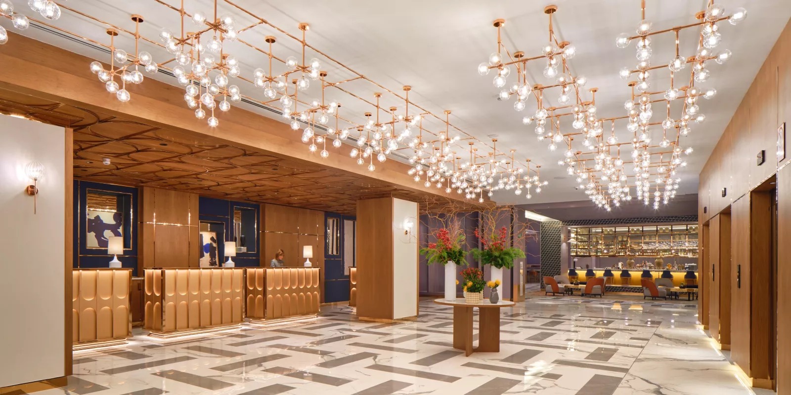 Lobby reception with sculptural gold pendant lighting