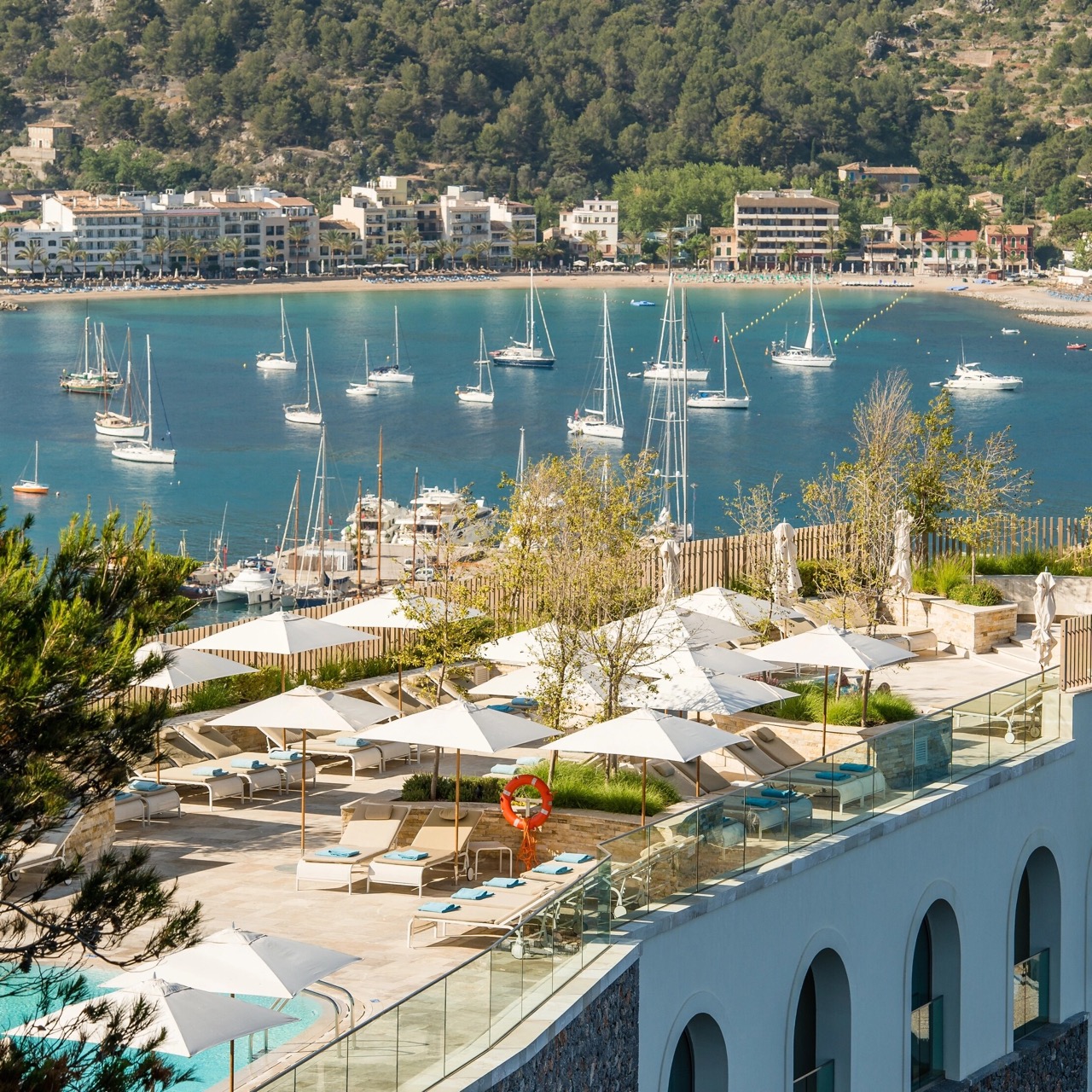 Rooftop terrace with sun loungers overlooking the marina and harbor