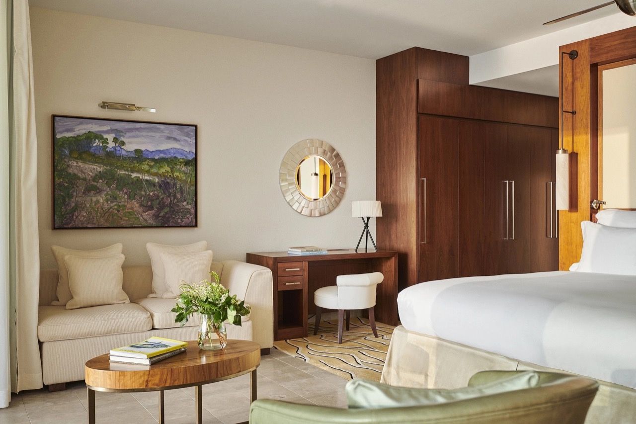 Suite living area with a cream sofa and framed artwork
