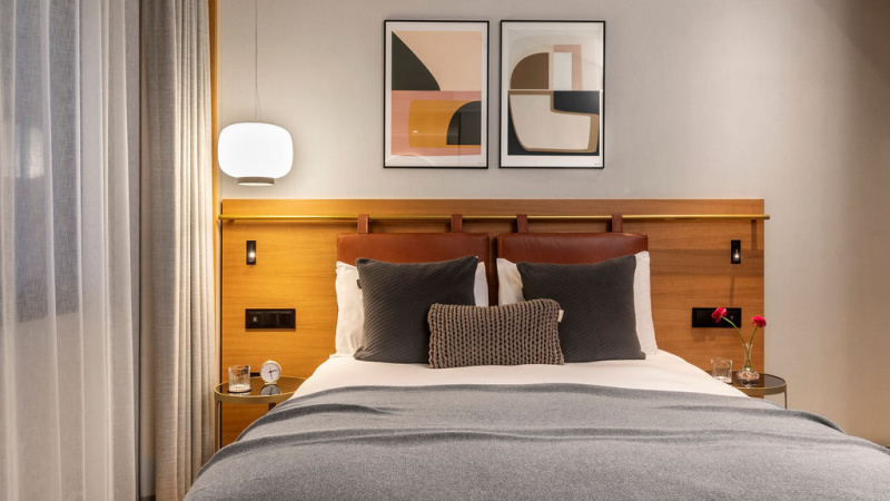 Queen Essential room with a leather headboard and abstract art prints