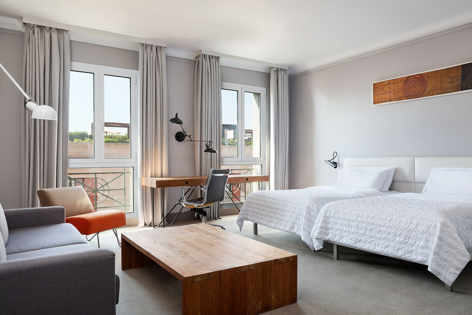 Junior Suite with a mustard velvet daybed and a private balcony over the street