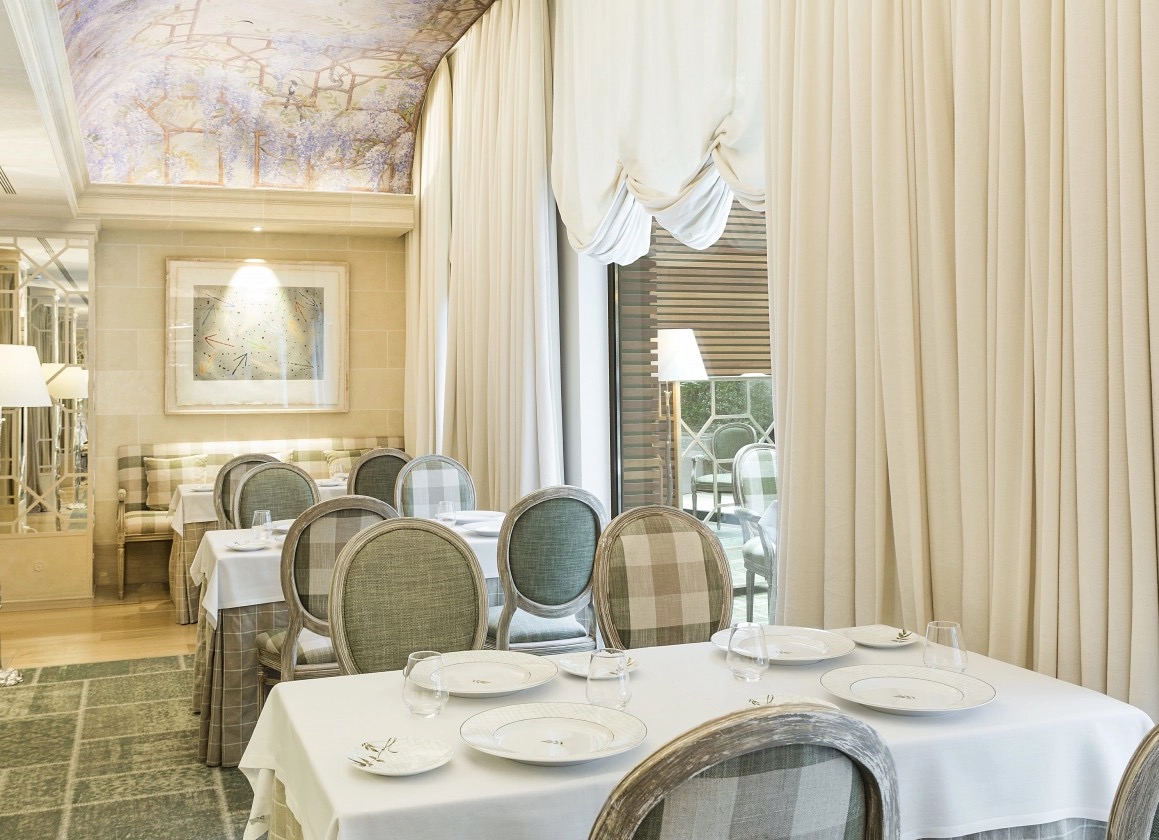 Restaurant SOLC dining room set for service beneath a painted ceiling