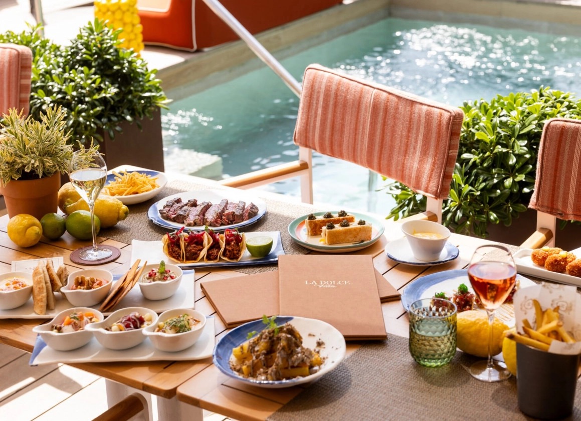 La Dolce Vitae rooftop terrace beside the pool with the city beyond