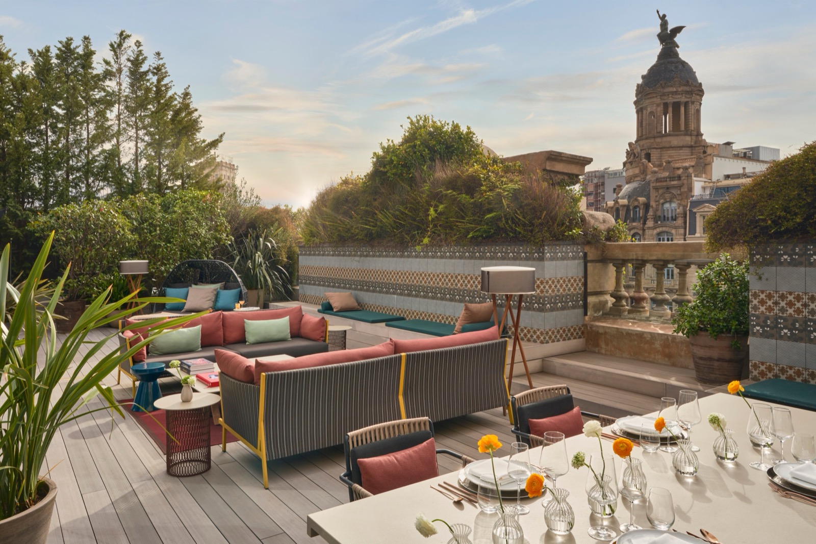 Barcelona Suite rooftop terrace with lounge seating, a dining table and city skyline views