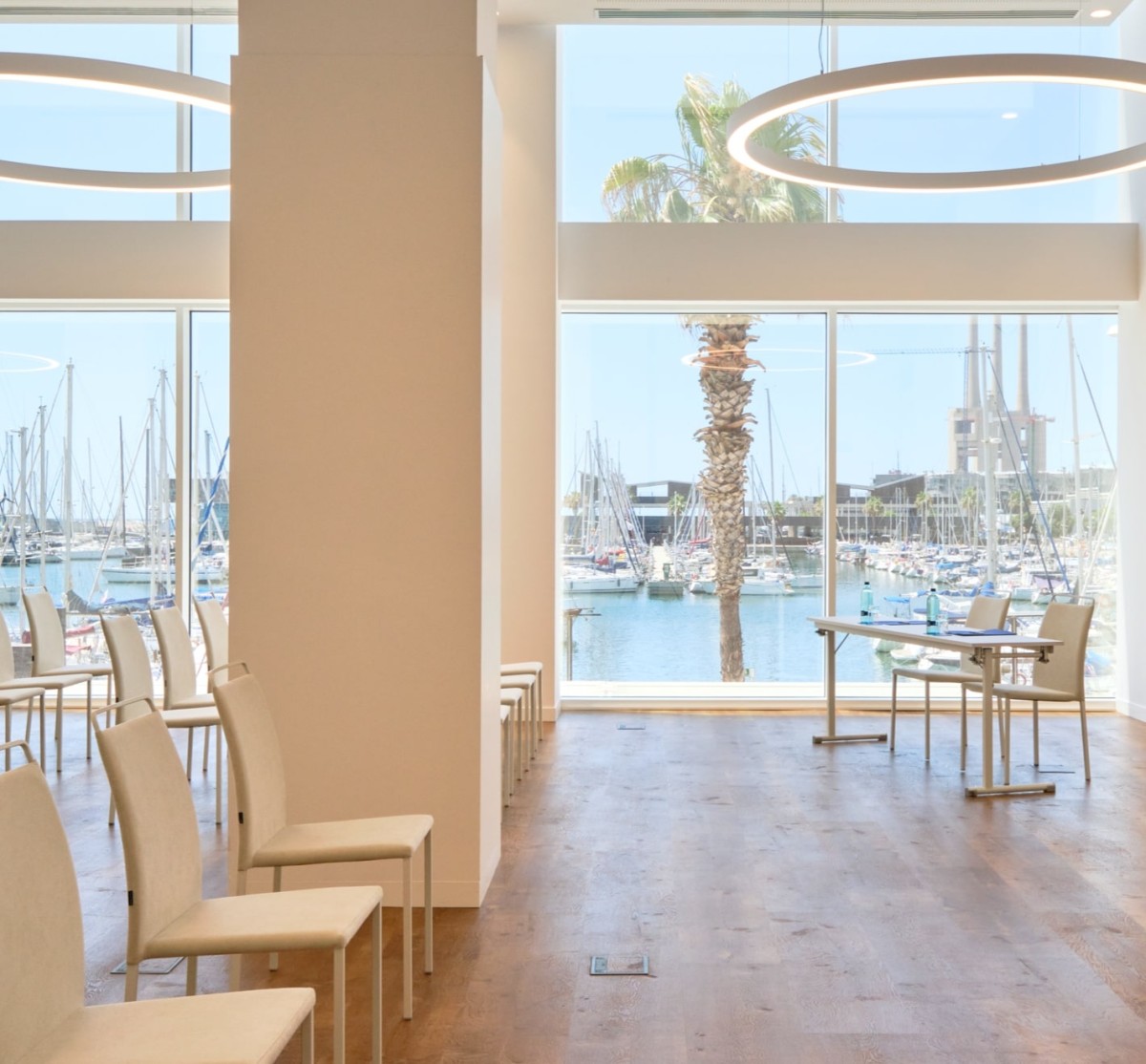Event room with floor-to-ceiling windows overlooking the marina