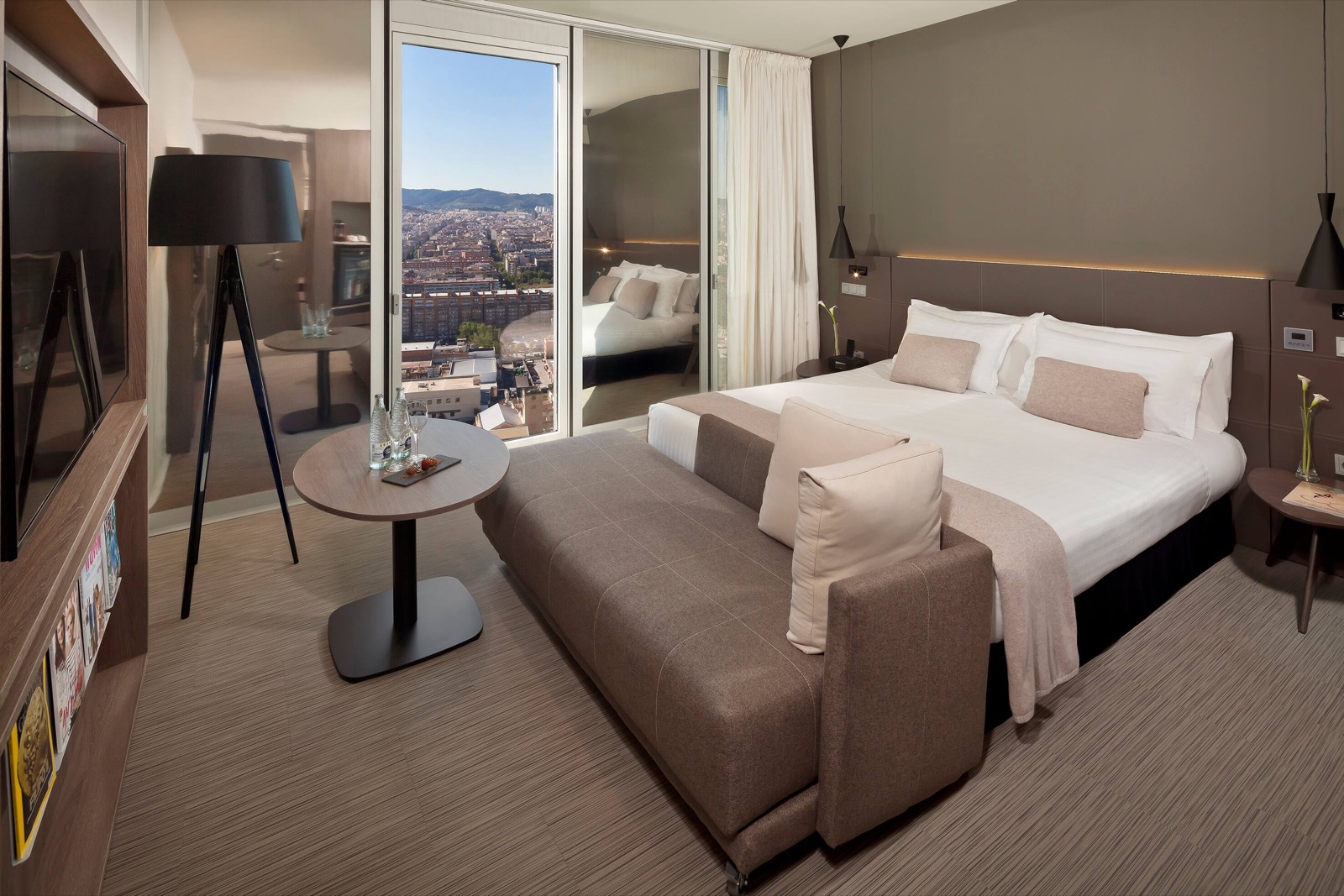 Suite bedroom with a panoramic Barcelona skyline view