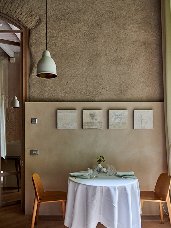 Mercer Restaurant dining room set beneath a vaulted stone archway