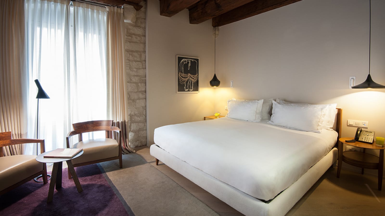 Superior room bedroom with exposed wood ceiling beams