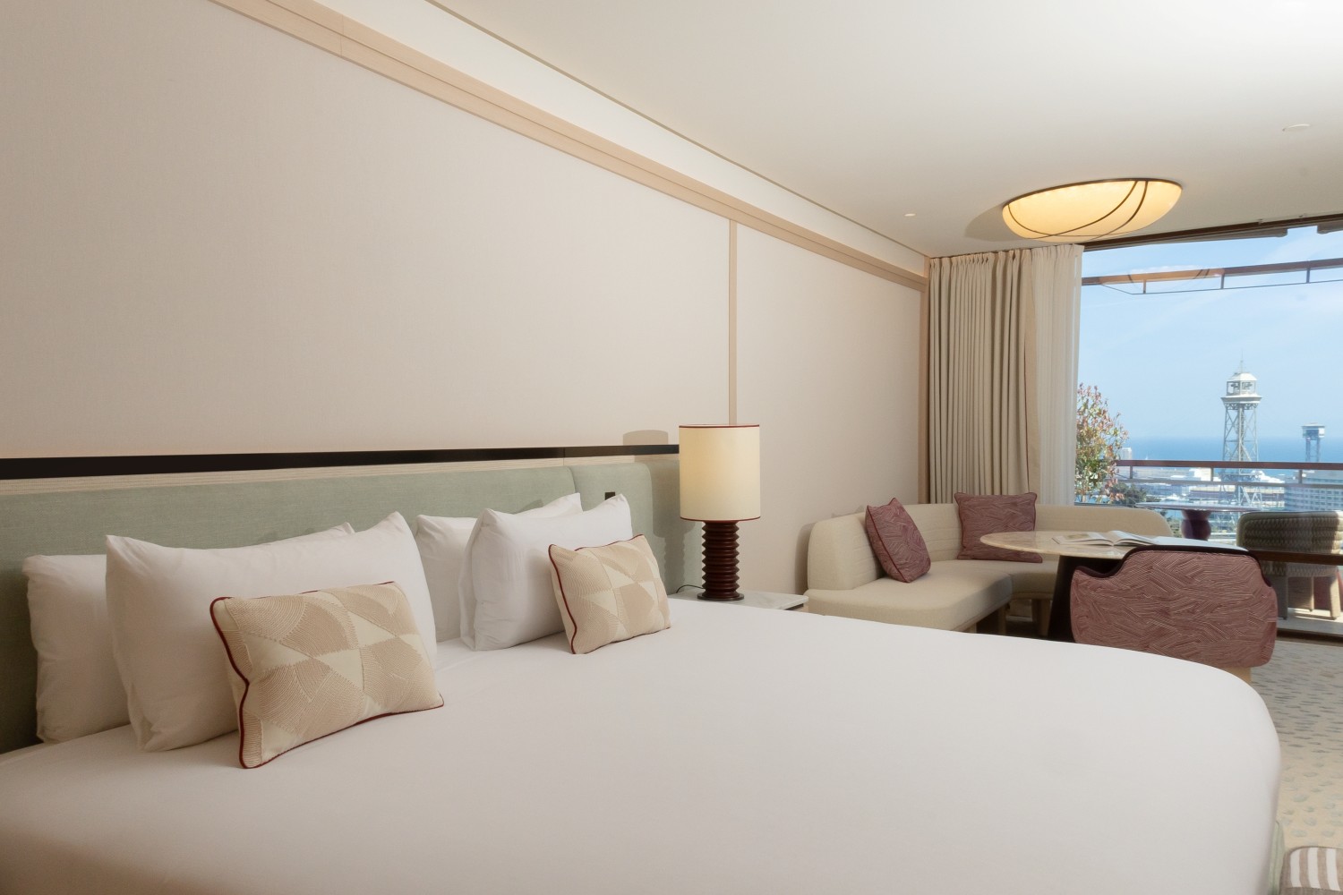 Guest room bed with a city and cable-car-tower view