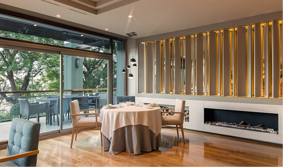Restaurant dining room with a terrace view and a fireplace