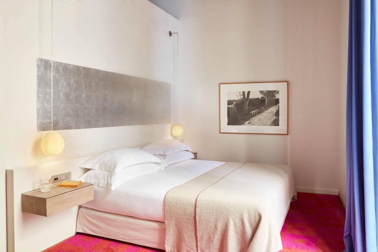 Hotel Neri classic guest room with a silver-leaf headboard