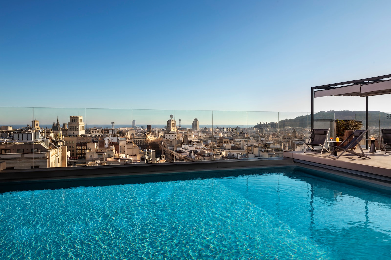 Rooftop pool at the Eleven BCN terrace with a Barcelona skyline view