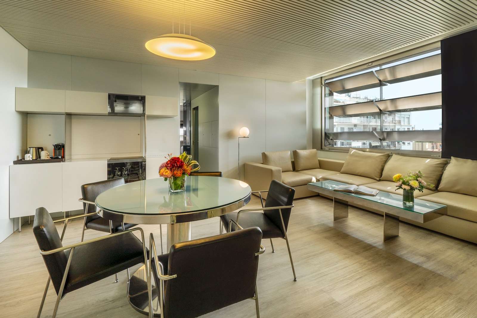 Suite dining and living area with a round table and a leather sectional