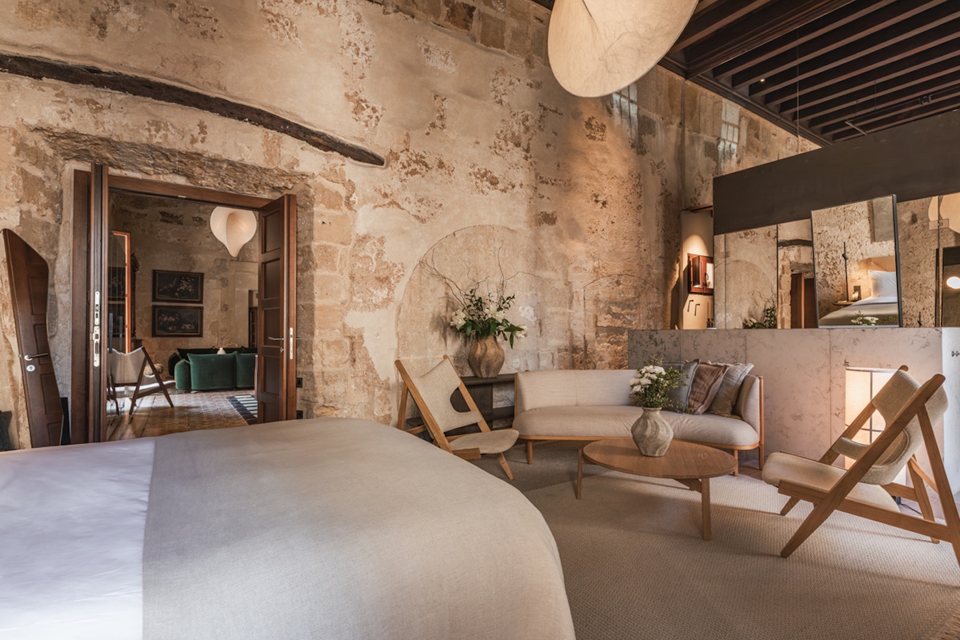 Suite with exposed stone walls and a private terrace sitting area