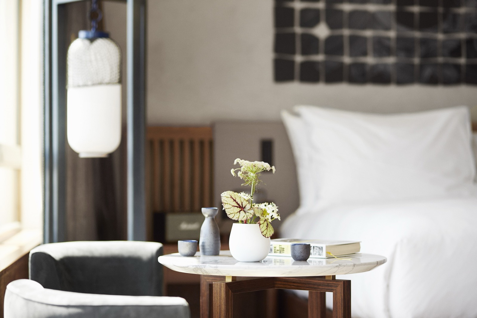 Zen Junior Suite bedside detail with flowers and a sake set