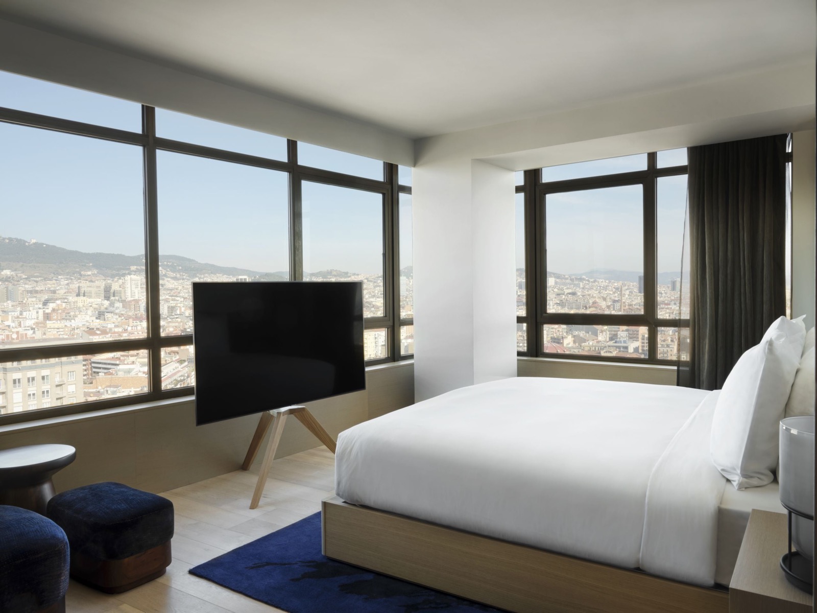 Nobu Suite bedroom with floor-to-ceiling windows over the Barcelona skyline