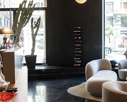 Reception and check-in area with globe pendant lights and a glass street entrance
