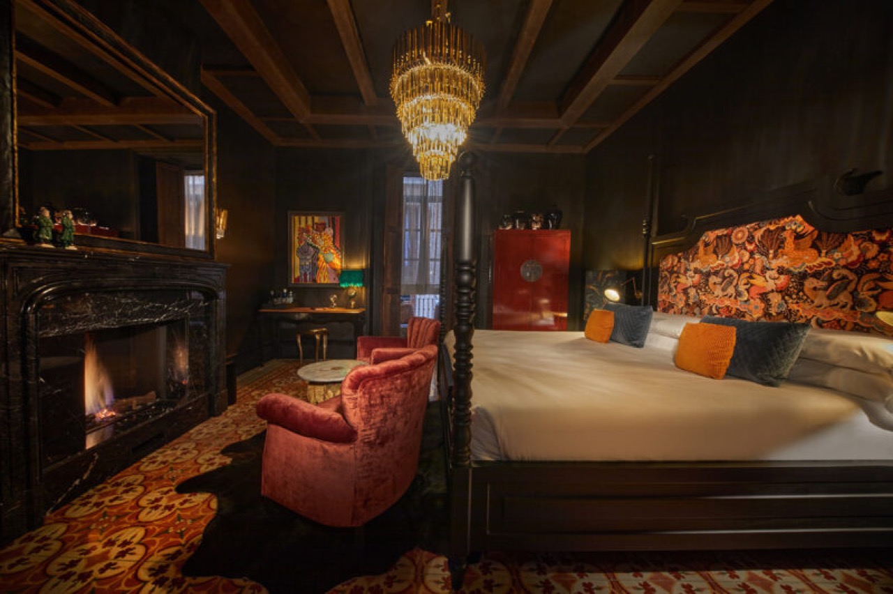 Suite at Palma Riad with a four poster bed, patterned headboard and a working fireplace