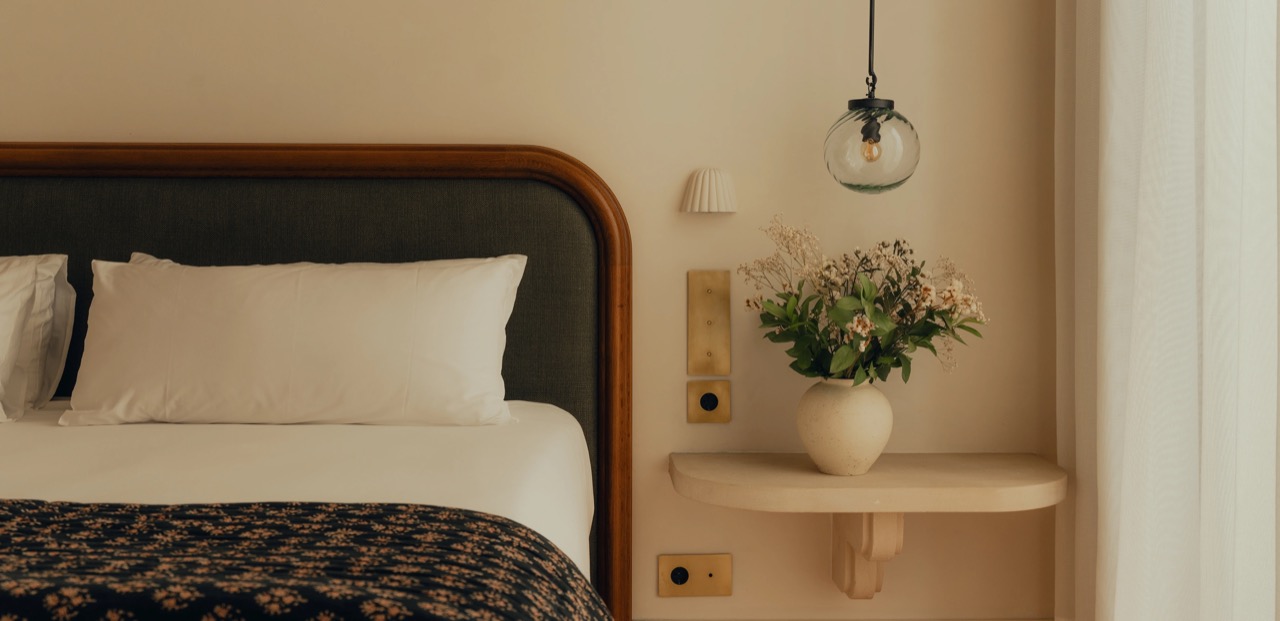 Bedroom detail with a wood framed headboard and bedside shelf