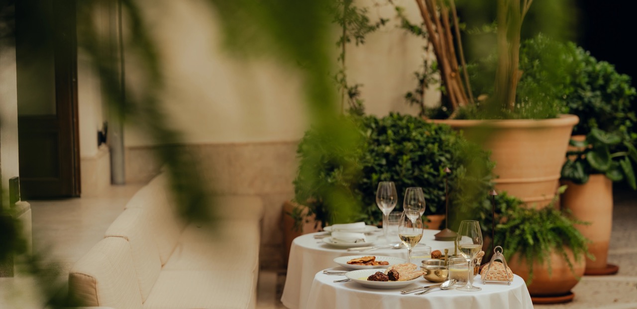 Table set for dining in the plant filled courtyard