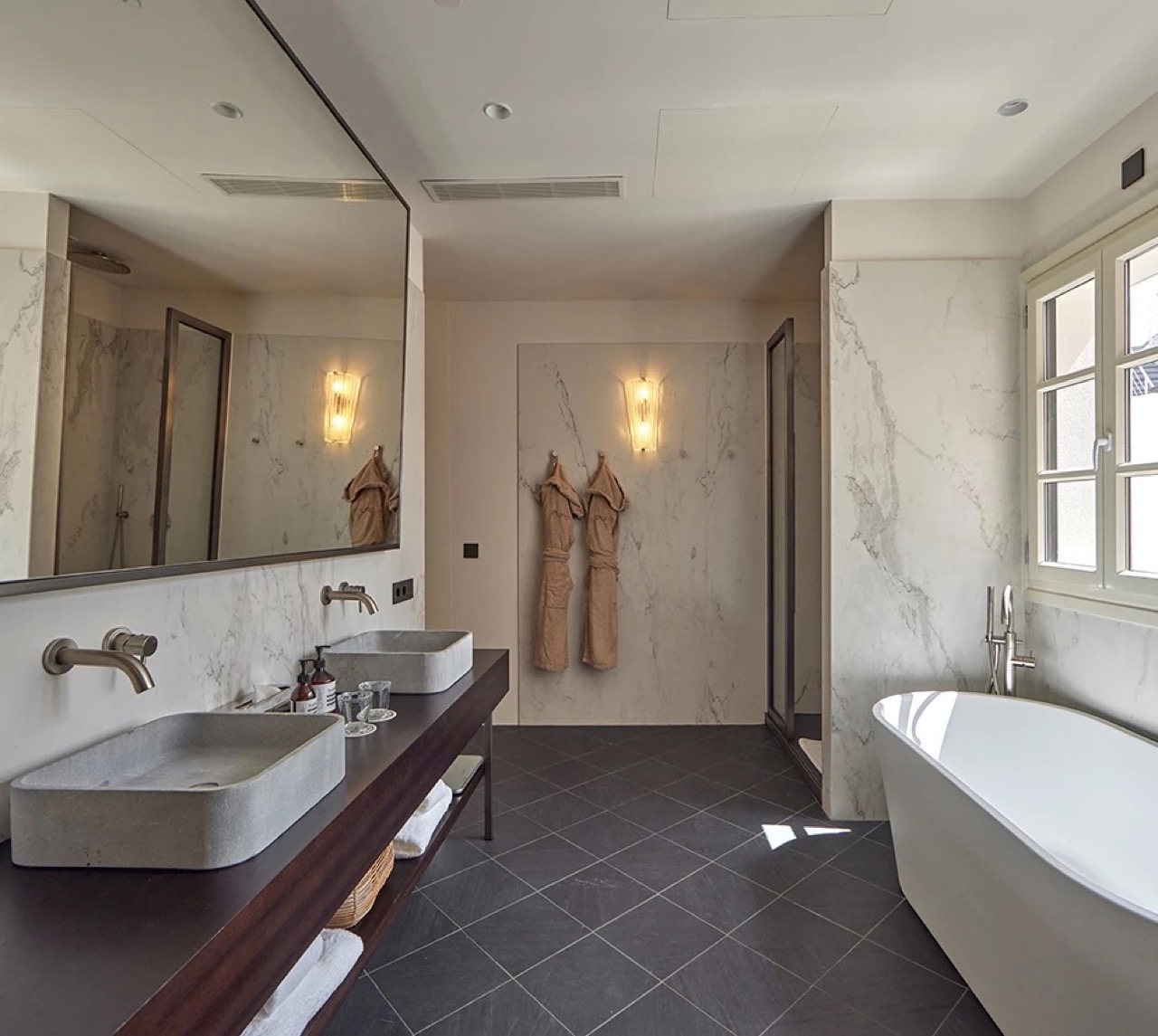 Marble bathroom with freestanding tub at Puro Grand Hotel