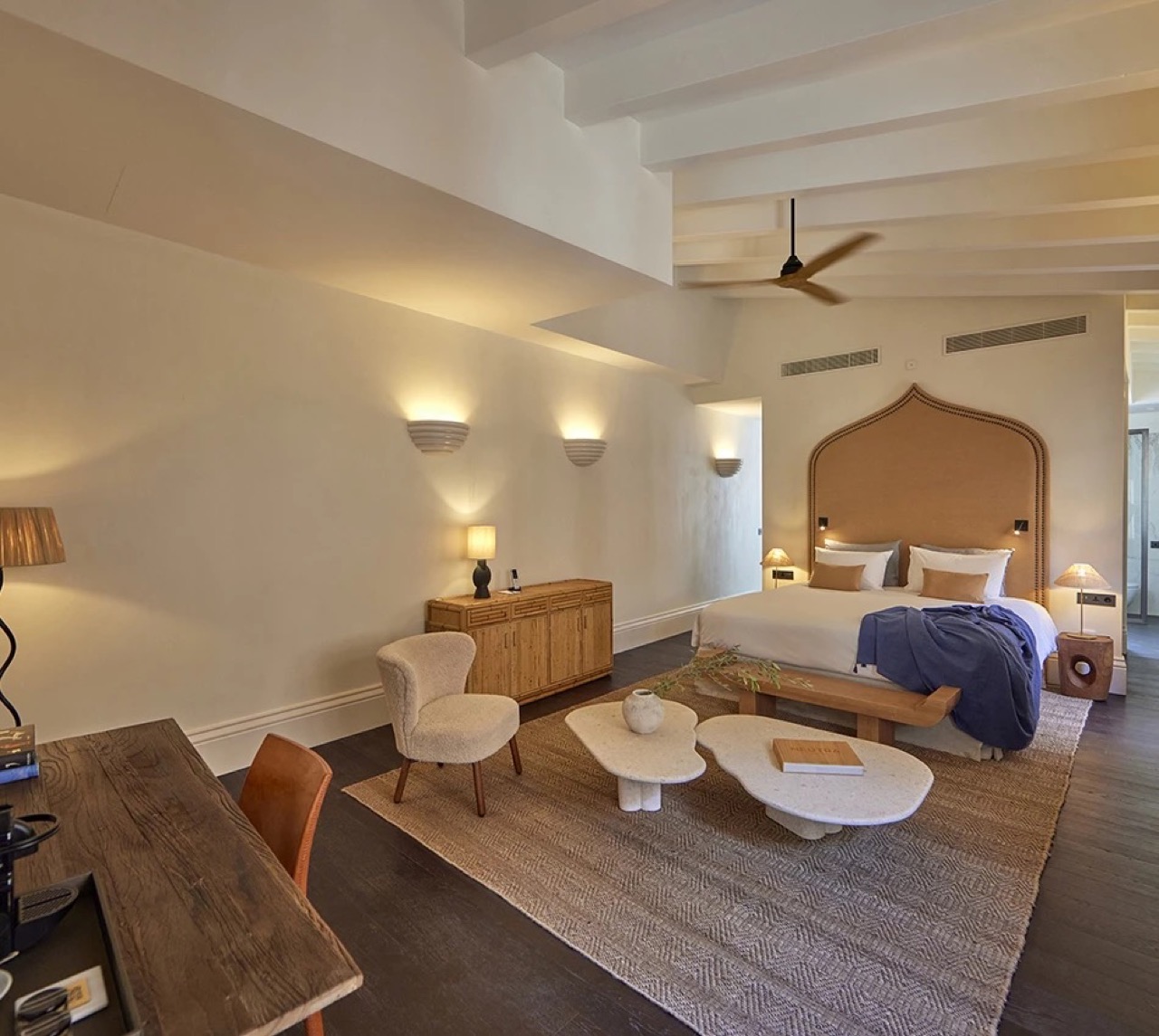 Suite bedroom at Puro Grand Hotel with arched leather headboard