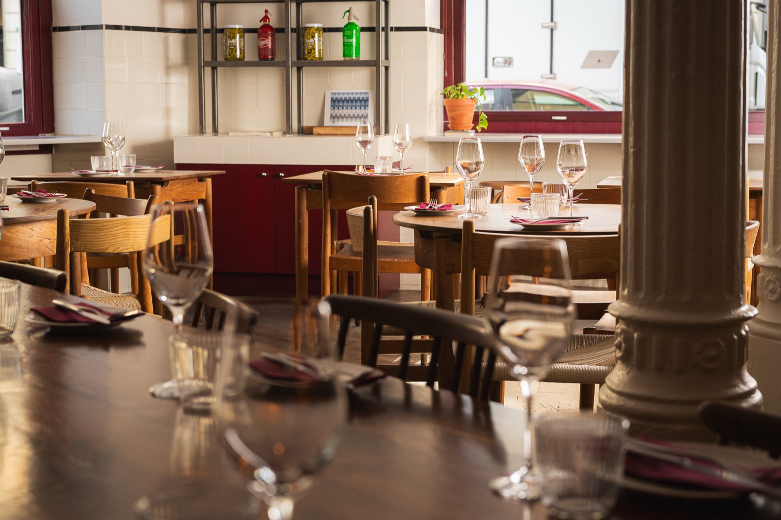 Restaurant with tiled walls and set tables by the window