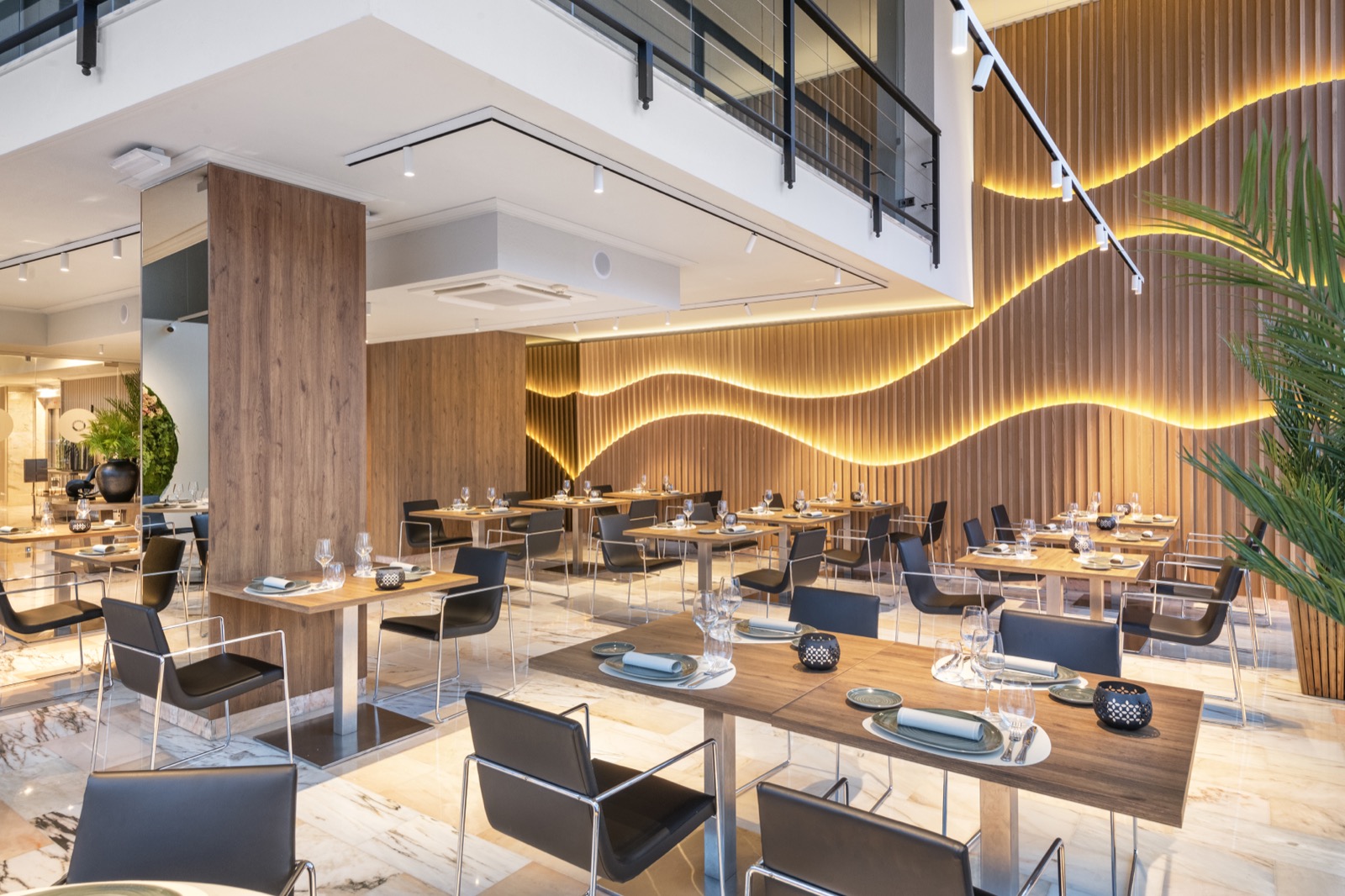 Hotel restaurant dining area with a wood-slat feature wall