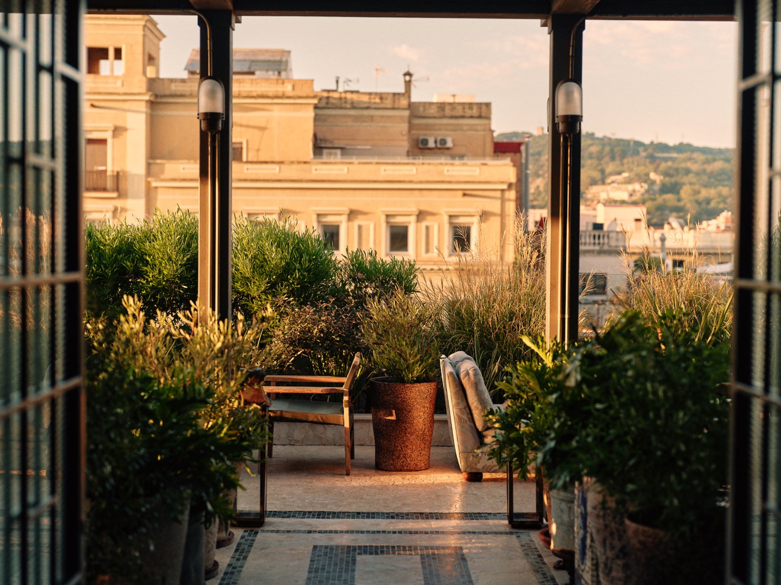 Rooftop terrace archway framed by greenery over the city