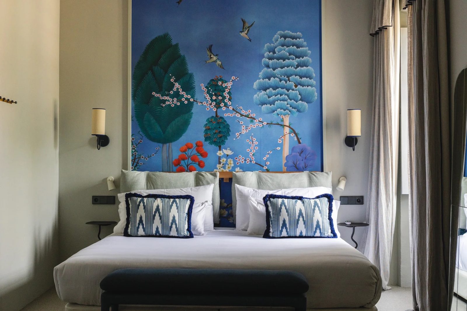 Double room with a king-size bed and a blue painted mural headboard wall