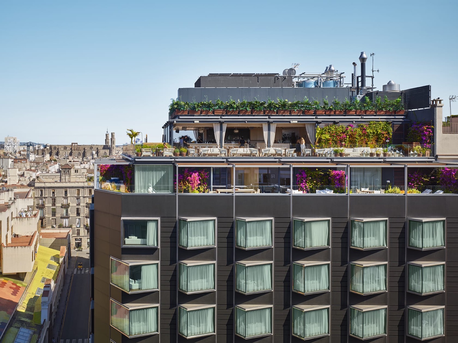 Exterior with cantilevered window bays and a rooftop terrace