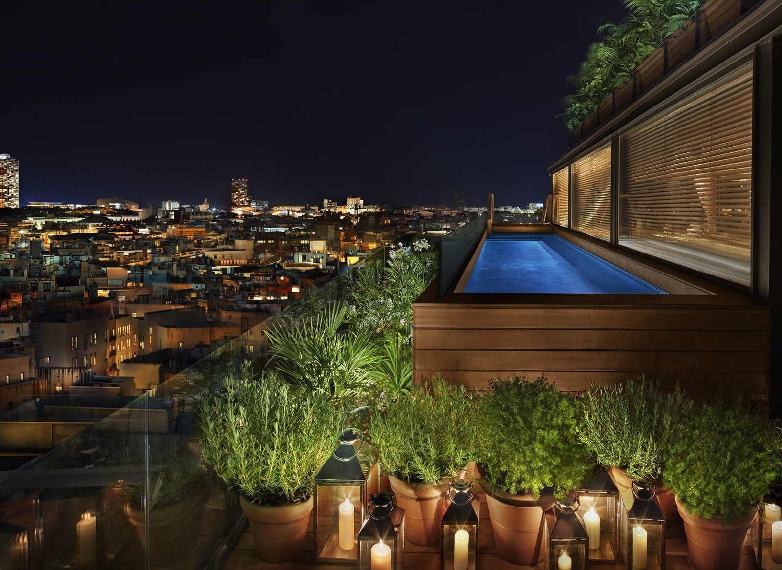 Private rooftop plunge pool at night with the city skyline