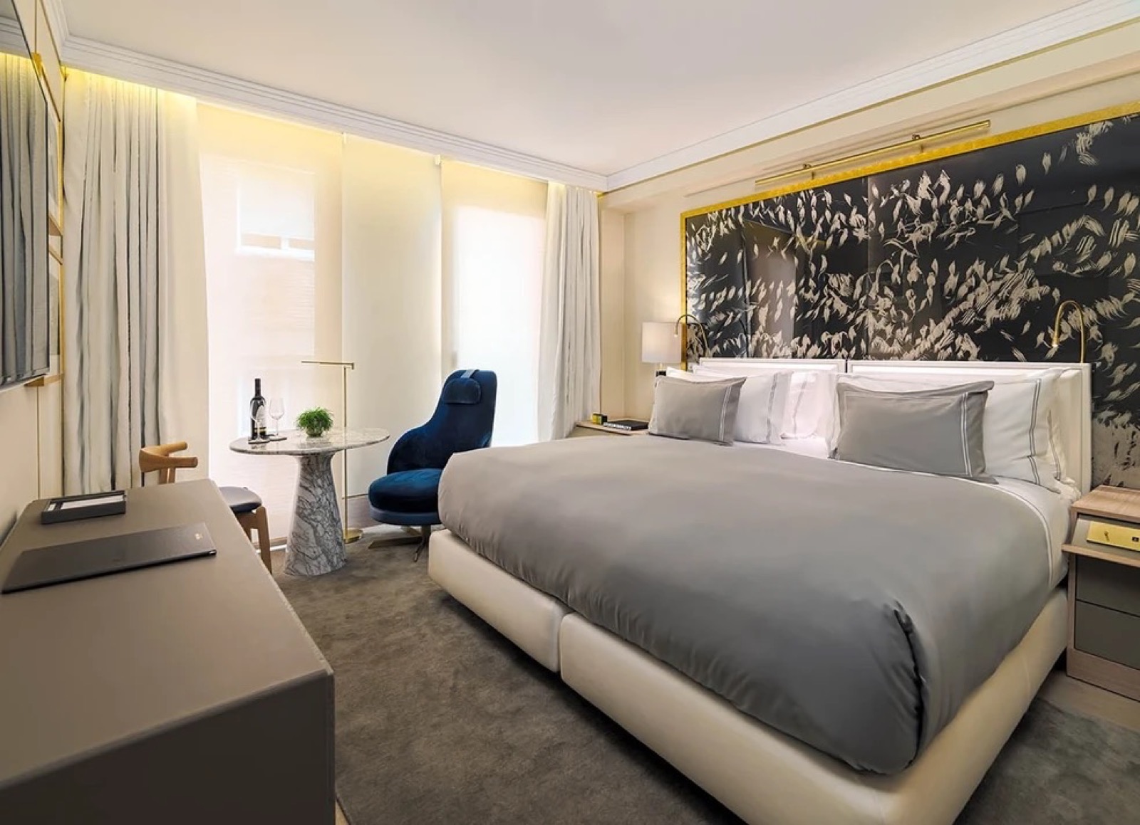 Cosy room with a king bed and a dark feather-motif headboard