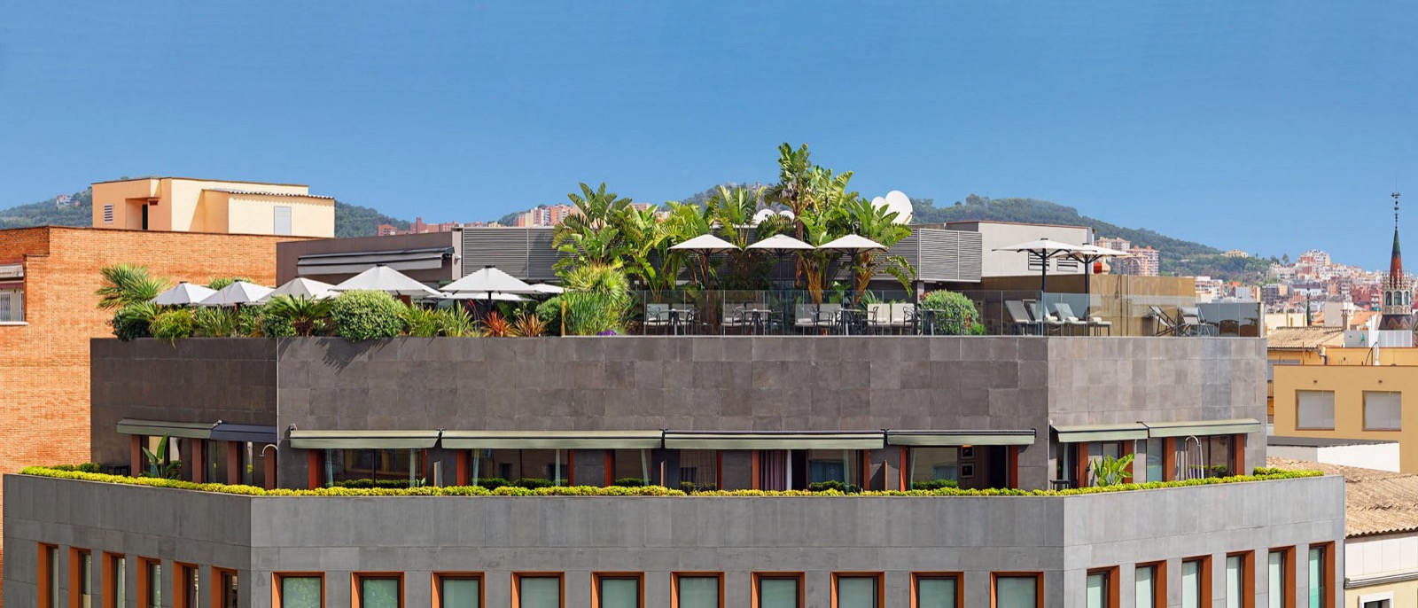 The One Barcelona exterior with its rooftop terrace, seen from a neighbouring rooftop